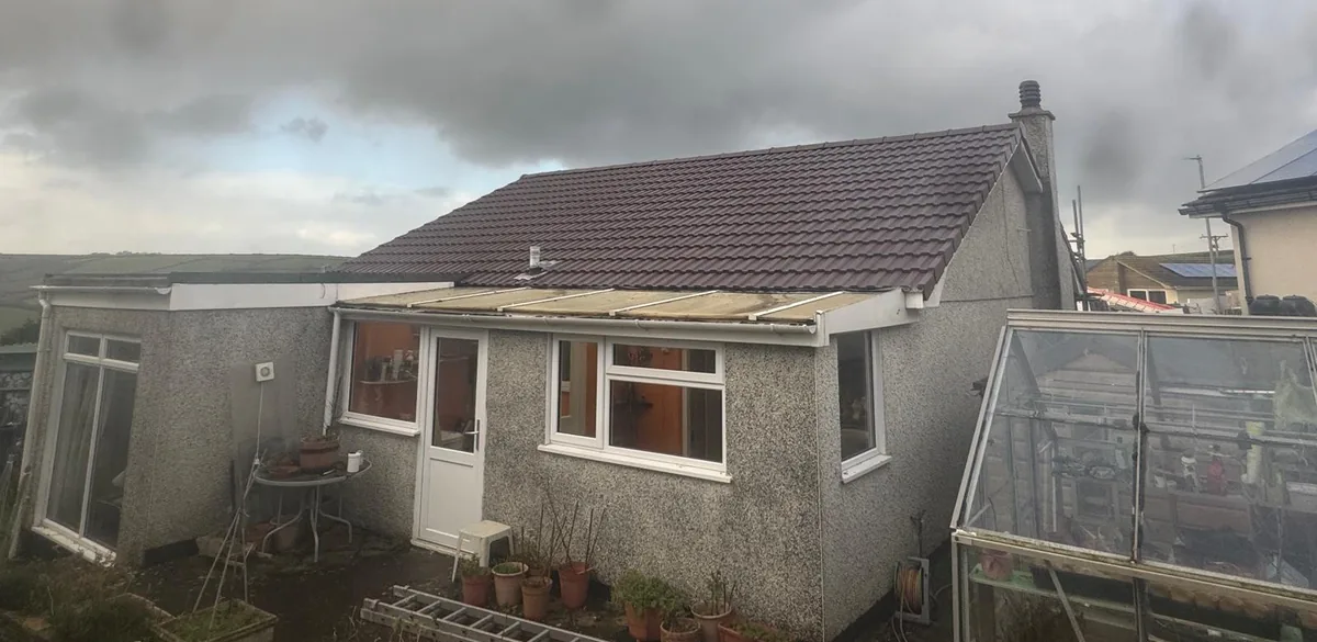 Bungalow with a new tiled roof over rendered walls, completed by Southridge