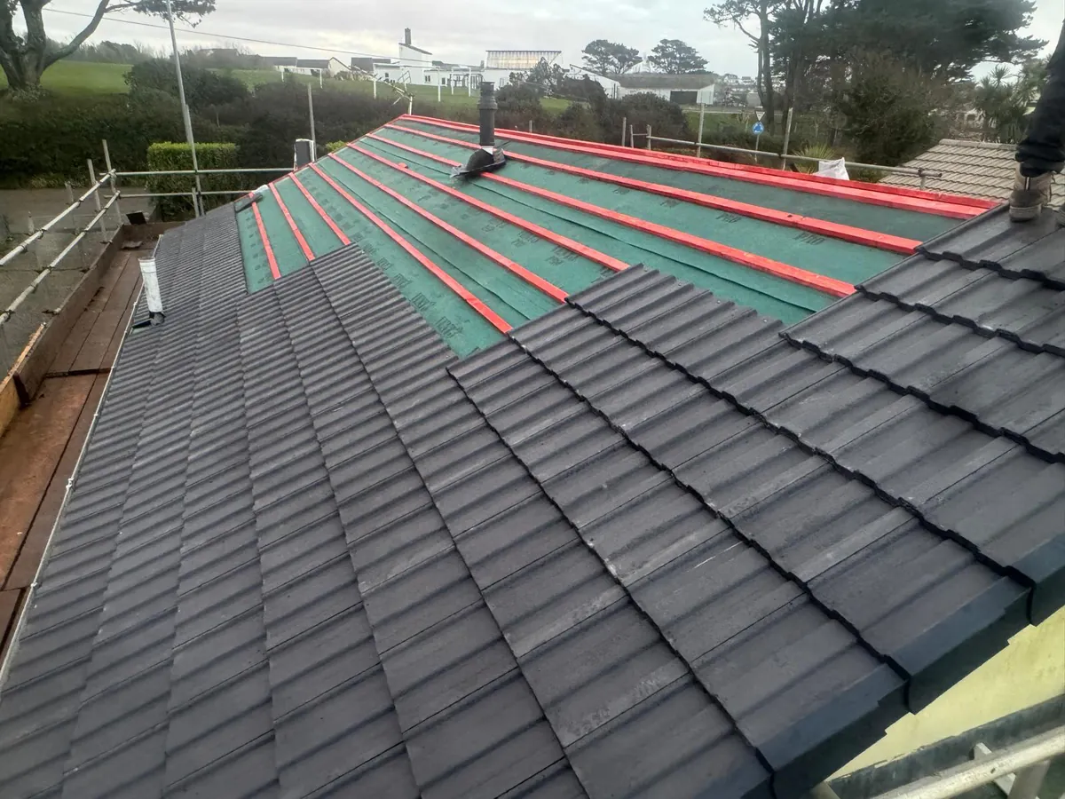 Re-roof in progress showing breathable membrane, treated battens and tiles half laid