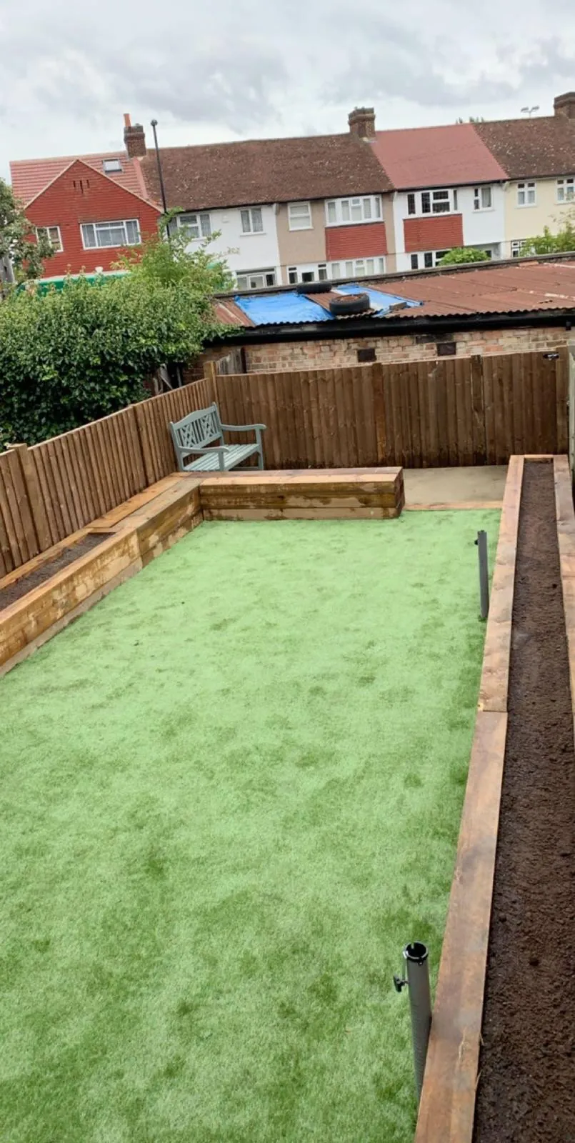 Artificial grass lawn with sleeper raised beds and new fencing