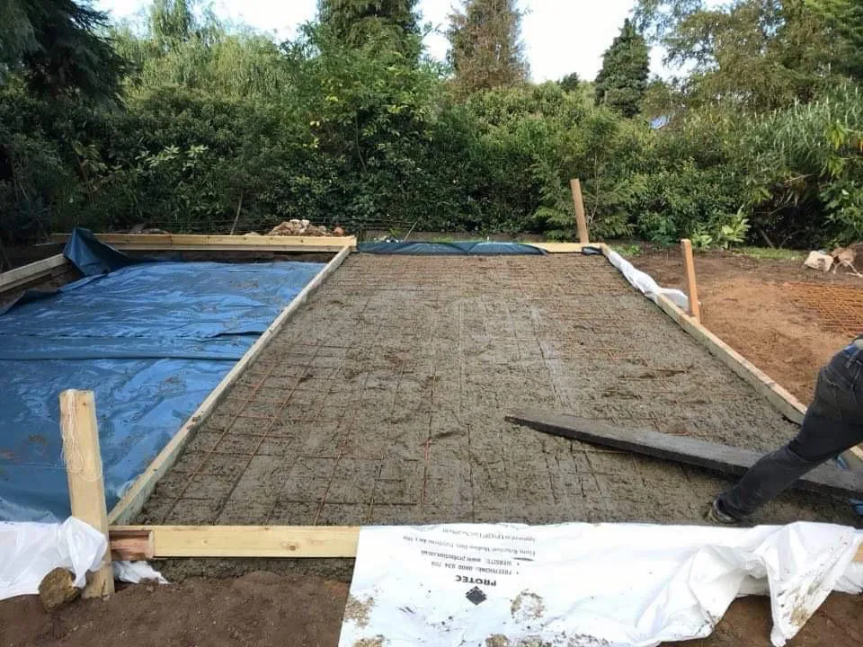 Concrete base being prepared with timber formwork, membrane and steel reinforcement mesh