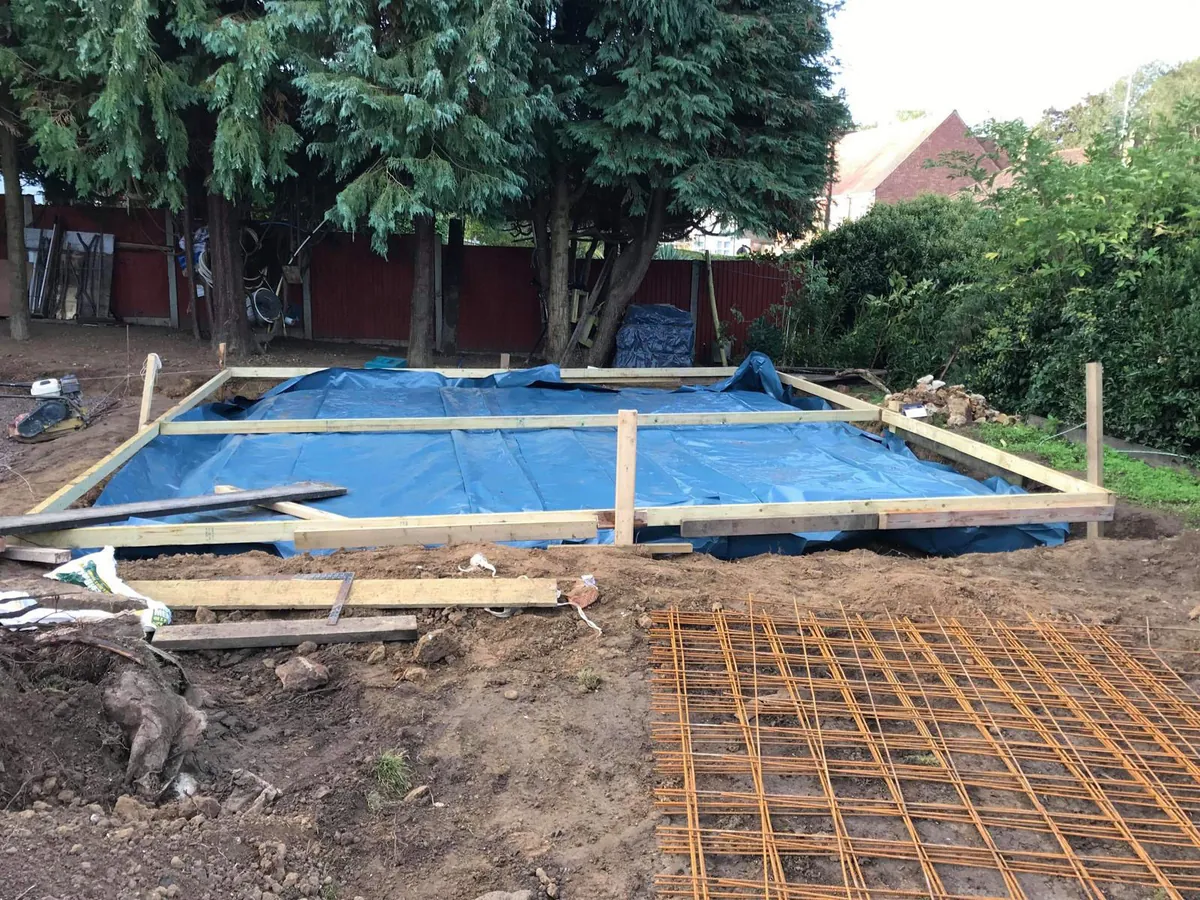 Ground dug out with timber formwork, damp proof membrane and steel mesh ready for concrete