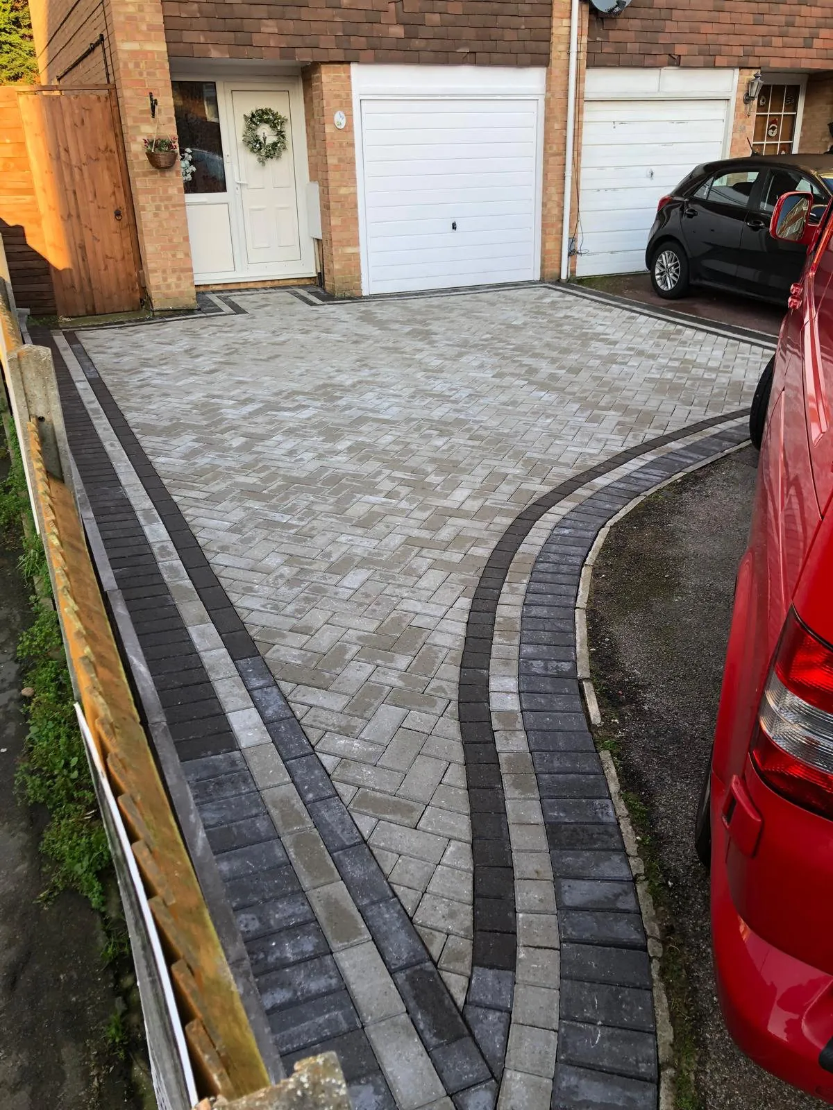 Block paved driveway with a curved dark border, laid by Southridge