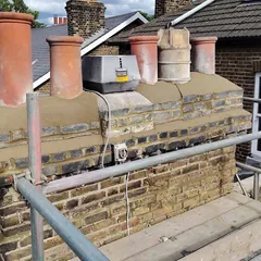 A chimney stack we repointed, with new flaunching round the pots