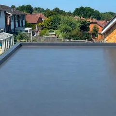 A flat roof we finished in a smooth grey covering, with a raised trim along its edges