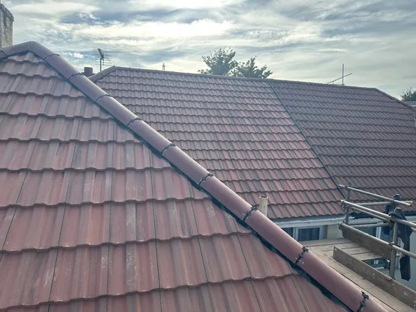 A red tiled roof of ours with the ridge and hips clipped down dry
